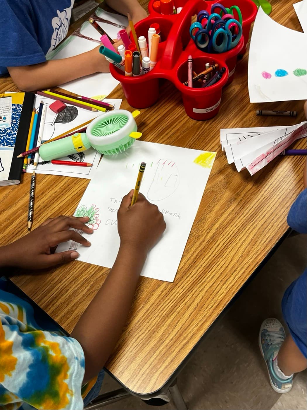 Elementary students drawing trees during a 4 Green Futures arts and crafts lesson