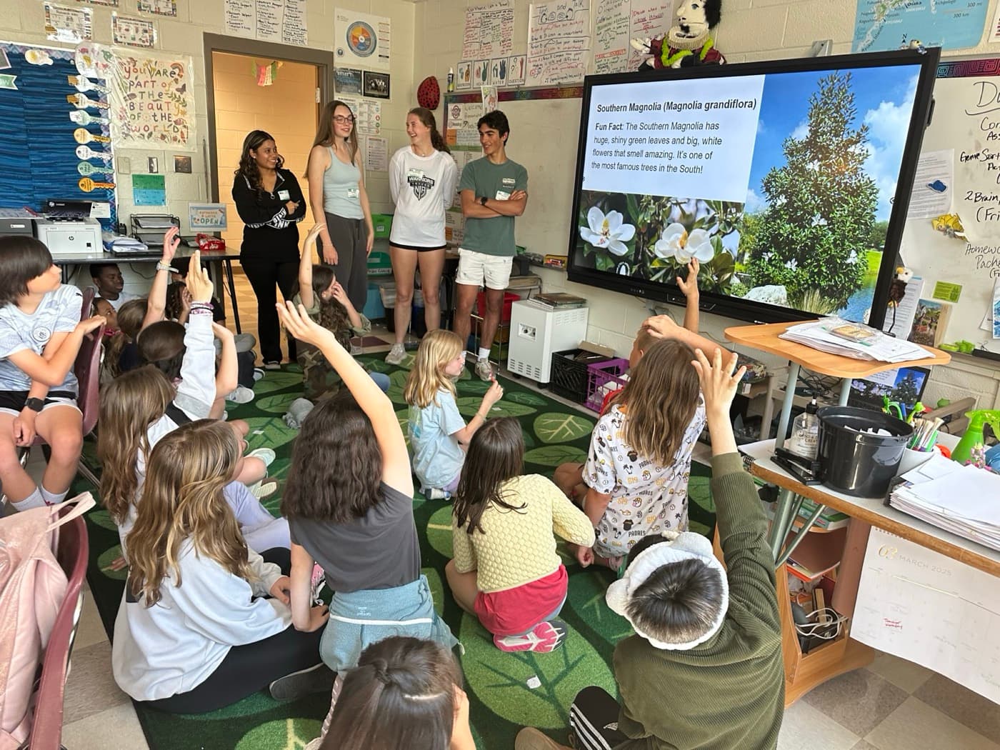 4 Green Futures mentors teaching an elementary class about native plant species